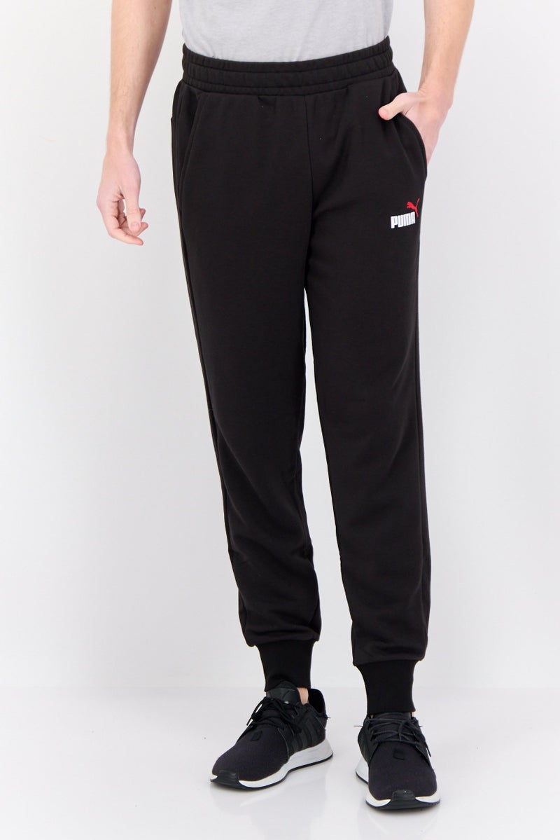 PUMA Men Sports Wear Fit Brand Logo Outdoor Sweatpants, Black - Image 1