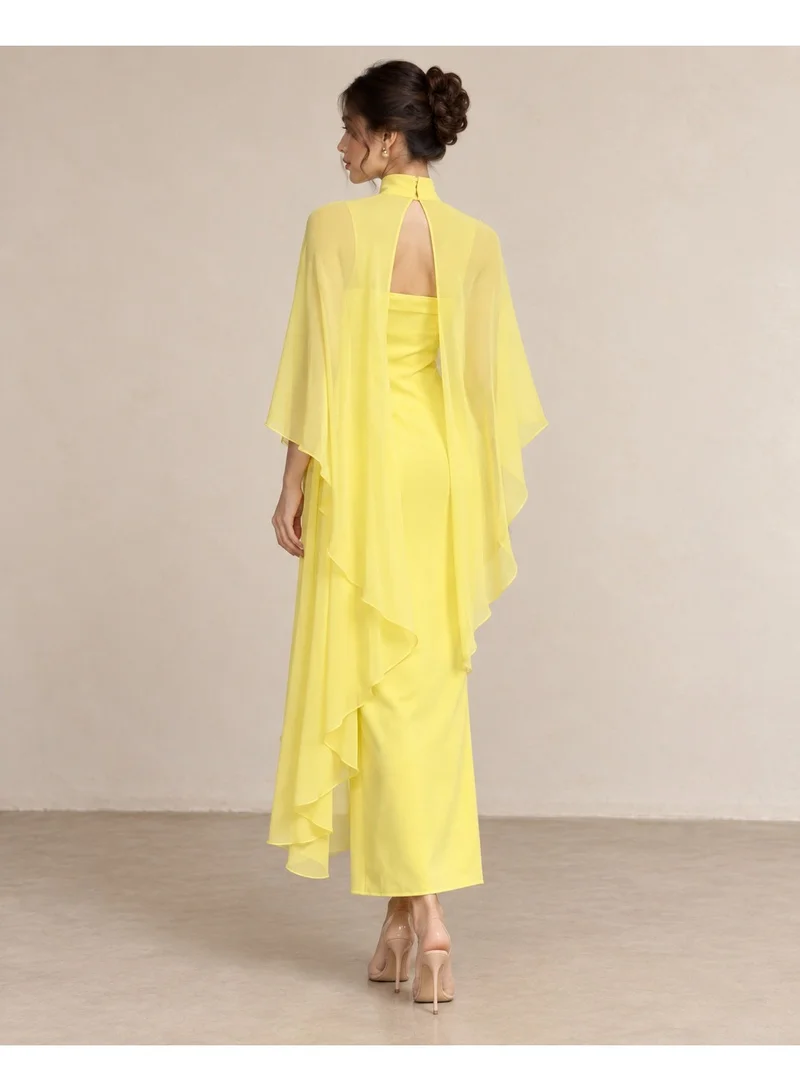 2Trendy Maxi Dress with Sheer Chiffon Cape, Wide Flowing Sleeves, High Neck and Open Back - Yellow