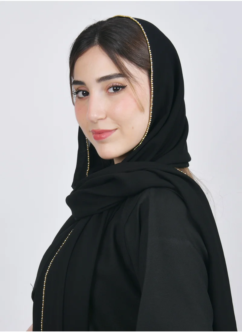 HAWRAA ABAYA A black silk veil with a small circular gold veil