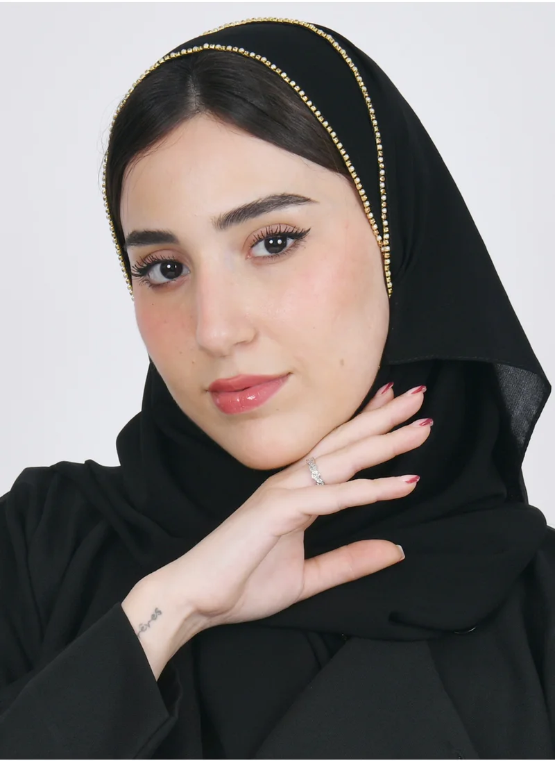 HAWRAA ABAYA A black silk veil with a small circular gold veil