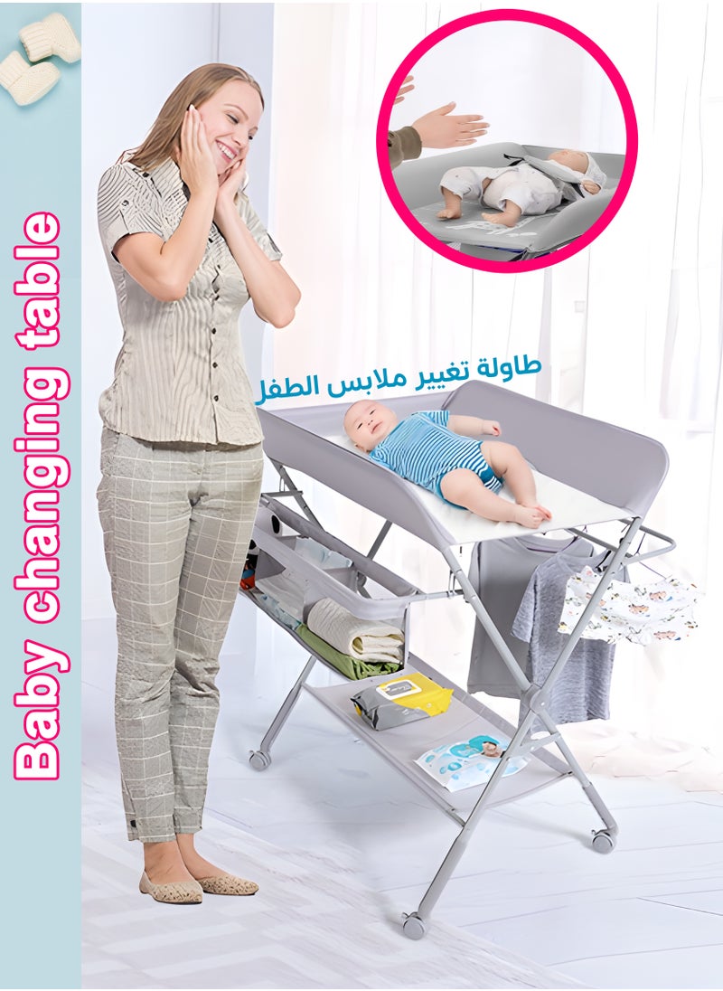 توشيونيكس - طاولة تغيير حفاضات قابلة للطي مع عجلات، ارتفاعات قابلة للتعديل، قماش أكسفورد مقاوم للماء، منظم حضانة محمول مع رف تخزين - محطة تغيير حفاضات متينة موفرة للمساحة للمواليد الجدد والرضع، متعددة الوظائف، إطار قوي، ارتفاع قابل للتعديل، سهلة التنظيف، عجلات قابلة للقفل، طاولة تدليك للأطفال، سطح تغيير آمن ومريح - Image 1