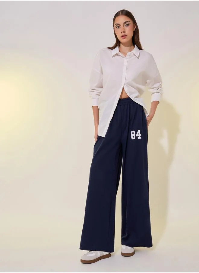 Styli Graphic Print Mid-Rise Wide Leg Pants