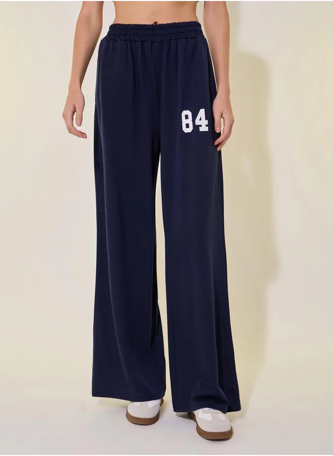 Styli Graphic Print Mid-Rise Wide Leg Pants