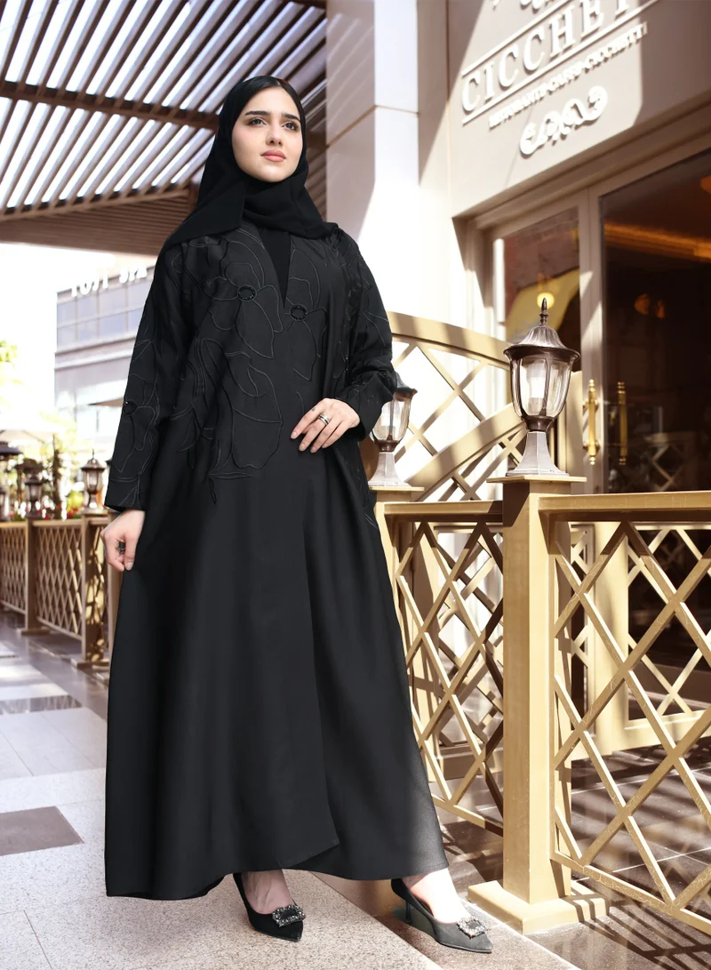 HAWRAA ABAYA A black quarter cloche abaya with luxurious black embroidery and a simple sash at the top of the abaya