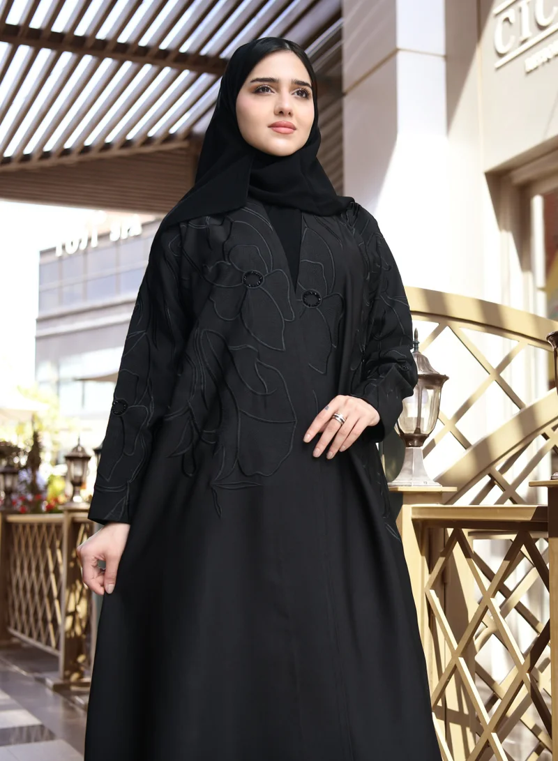 HAWRAA ABAYA A black quarter cloche abaya with luxurious black embroidery and a simple sash at the top of the abaya