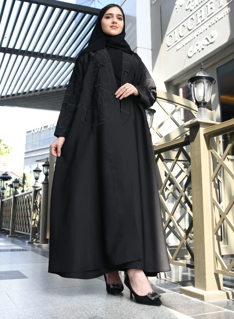 HAWRAA ABAYA A black quarter cloche abaya with luxurious black embroidery and a simple sash at the top of the abaya