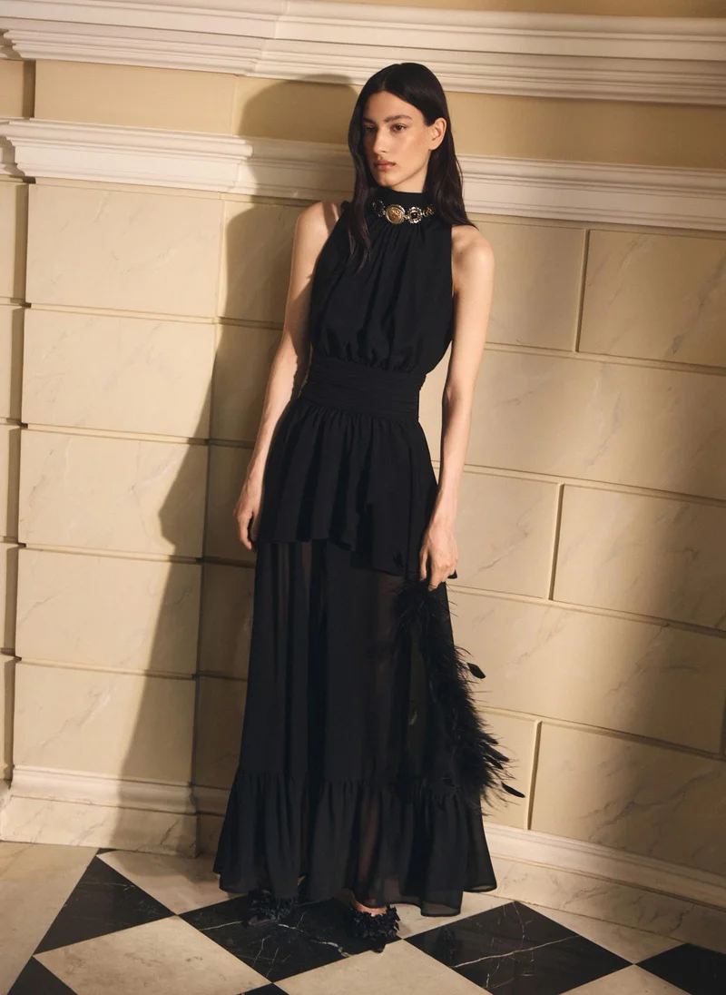 Maxi dress with ribbons on the bodice and a semi-sheer skirt