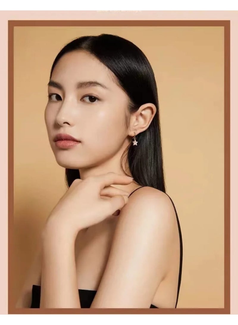 Luxuria Gold-tone hoop earrings with a dangling star coated in white enamel. - Image 2