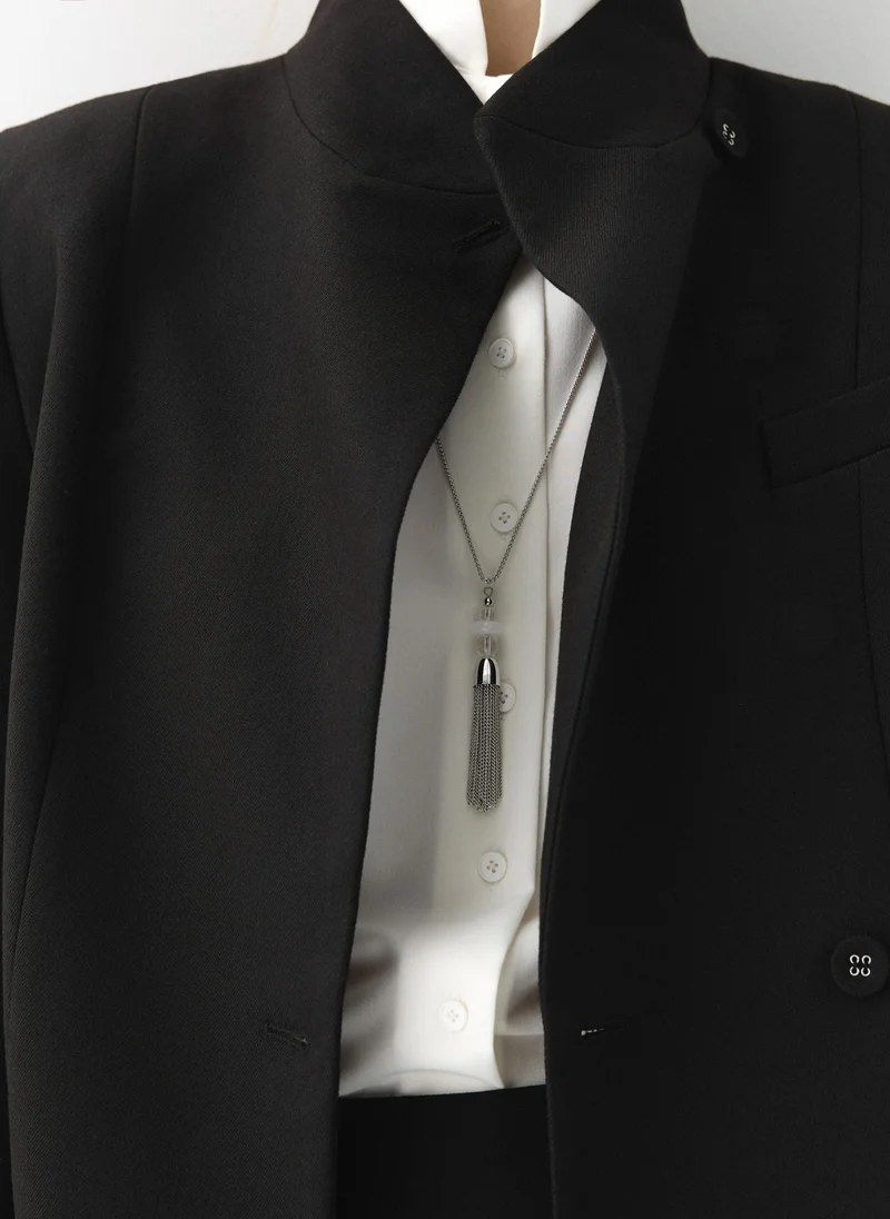 Silvertone chain with a tassel pendant