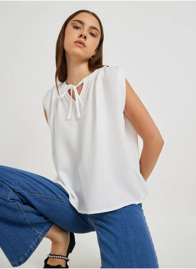 ستايلي Solid Sleeveless Tie-Up Neck Blouse