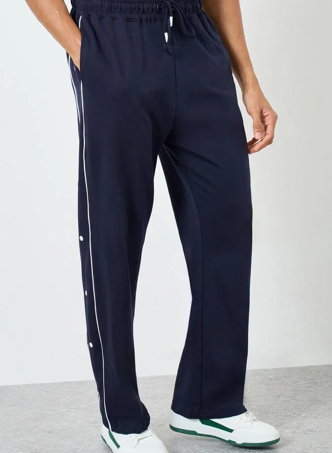 Styli  Contrast Piping and Popper Oversized Open Hem Joggers for Men | Best Price UAE