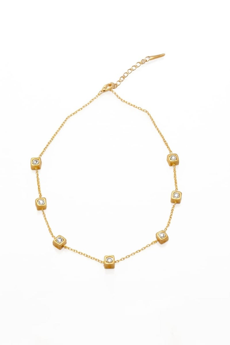 A delicate gold necklace studded with regularly distributed, shiny square stones, made of rust-resistant stainless steel with an adjustable clasp. - Image 1