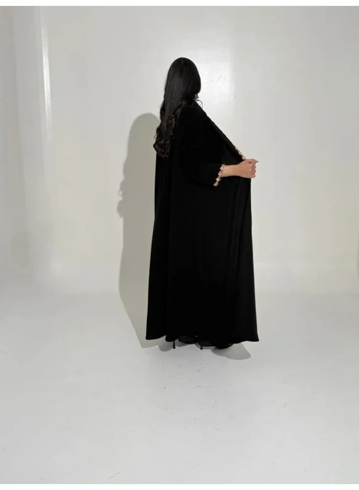 Tori-abaya Ceramic-finish abaya with dusty rose floral detailing.