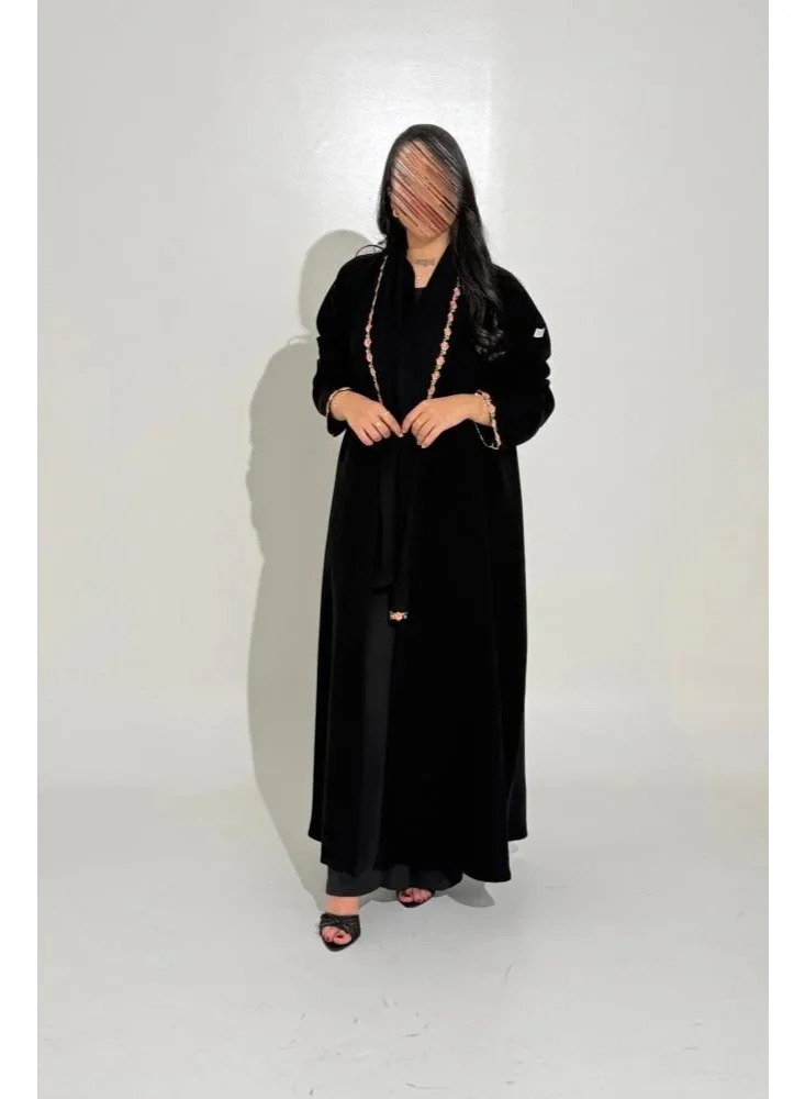 Tori-abaya Ceramic-finish abaya with dusty rose floral detailing.