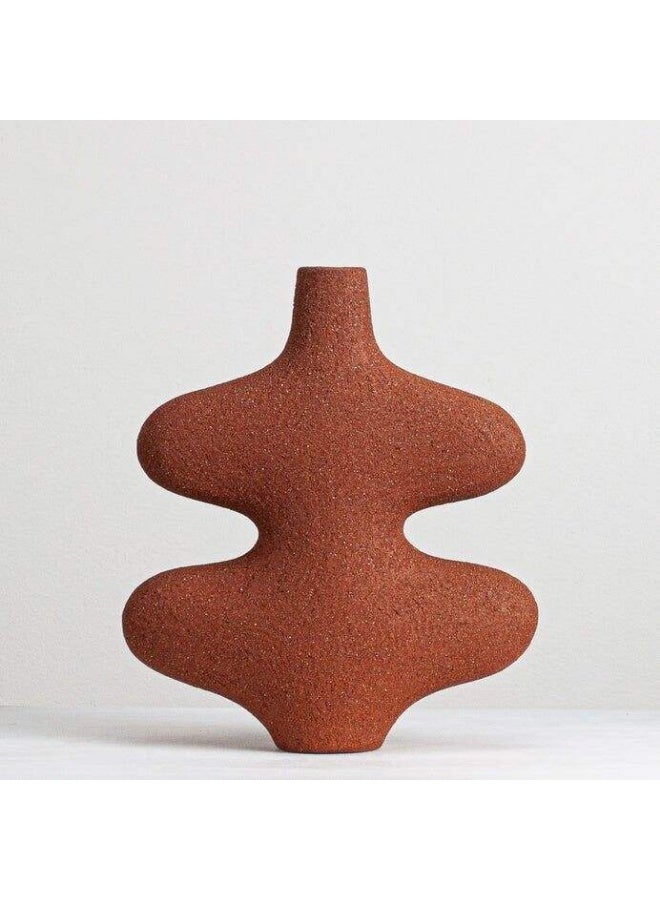 A wavy ceramic vase with an artistic design that adds a touch of elegance to your home. reddish-brown color .