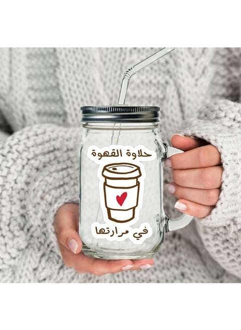 A jar for coffee juice and water with a sweet and bitter coffee print with a metal lid and a multicolored straw