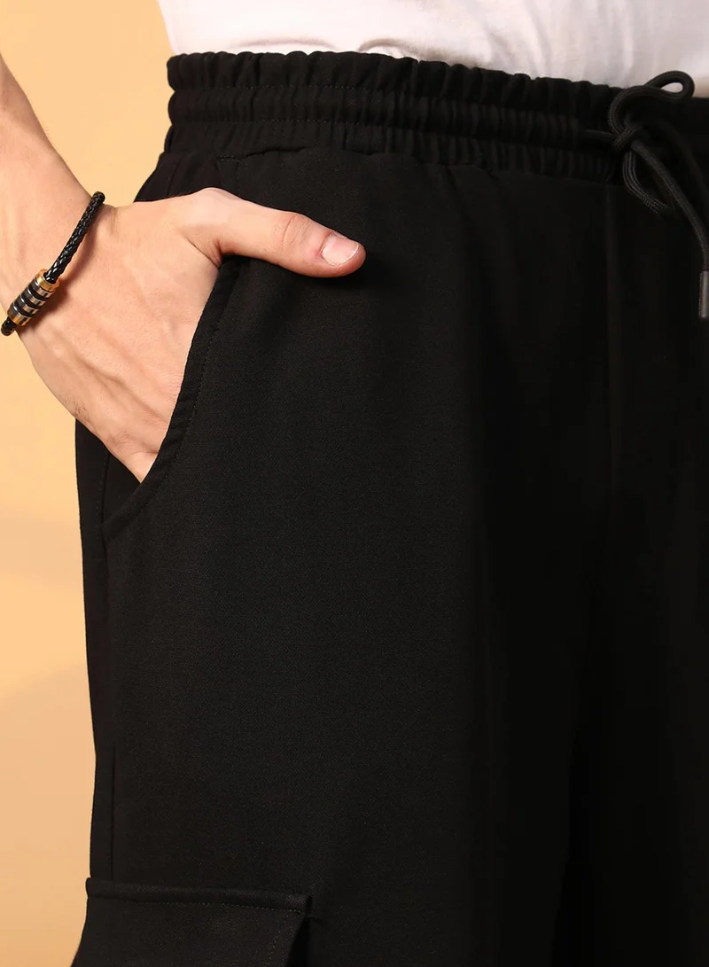 Campus Sutra  Men's Onyx Black Solid Cargo Parachute Trousers for Men | Best Price UAE