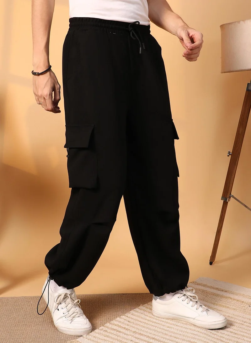 Campus Sutra  Men's Onyx Black Solid Cargo Parachute Trousers for Men | Best Price UAE