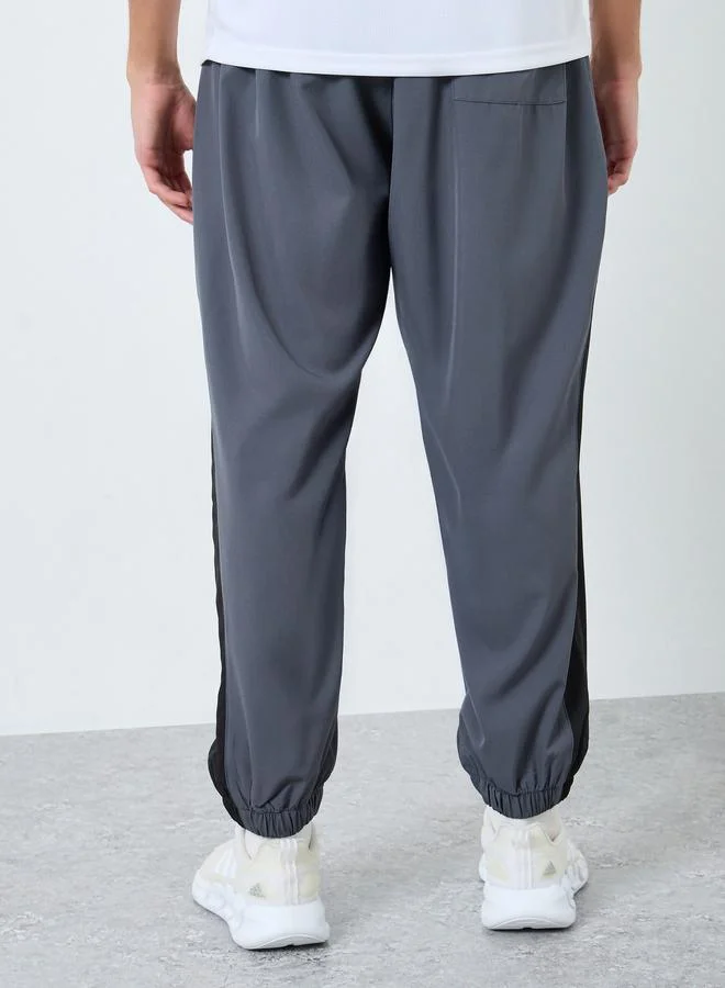 Styli  Styli Men Grey Placement Print Regular Fit Track Pants with Side Panel for Men | Best Price UAE