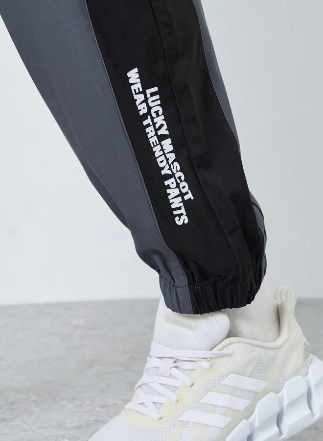 Styli  Styli Men Grey Placement Print Regular Fit Track Pants with Side Panel for Men | Best Price UAE