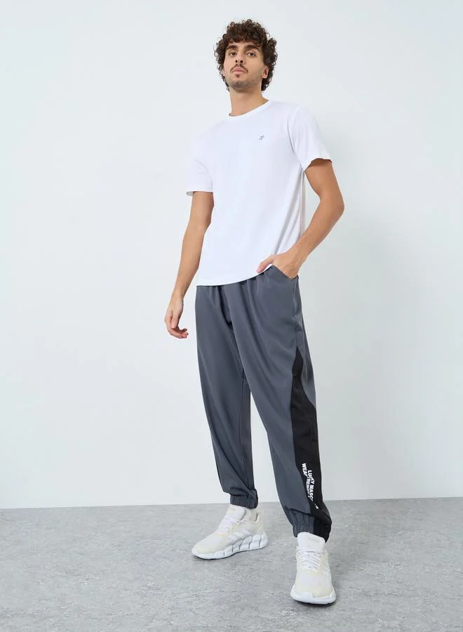Styli  Styli Men Grey Placement Print Regular Fit Track Pants with Side Panel for Men | Best Price UAE