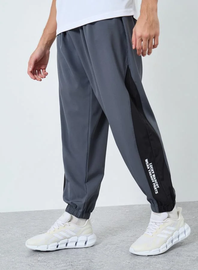 Styli Men Grey Placement Print Regular Fit Track Pants with Side Panel