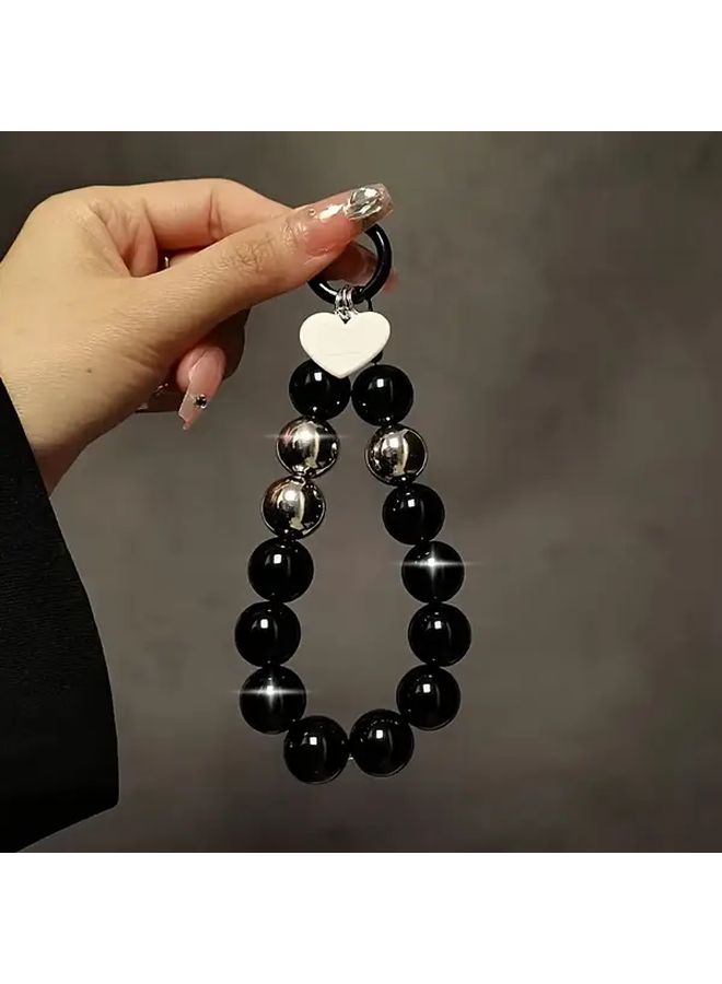 Black Beaded Phone Wrist Strap with Golden Clasp and Heart Charm - Image 1