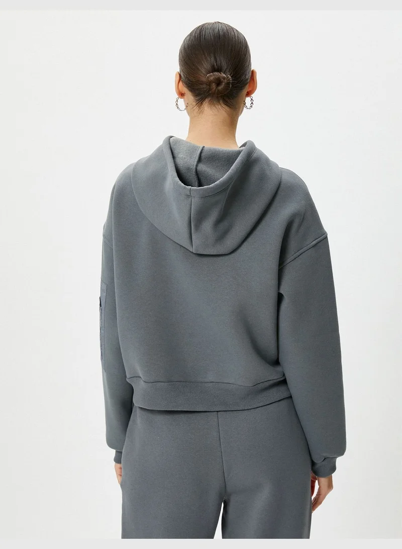 كوتون Hooded Crop Sweatshirt Parachute Fabric Soft Interior Zipper Pocket Detail at Sleeve