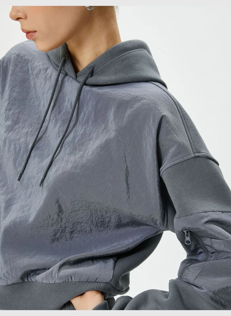 كوتون Hooded Crop Sweatshirt Parachute Fabric Soft Interior Zipper Pocket Detail at Sleeve