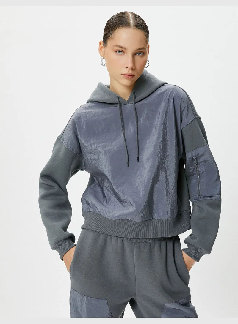 كوتون Hooded Crop Sweatshirt Parachute Fabric Soft Interior Zipper Pocket Detail at Sleeve
