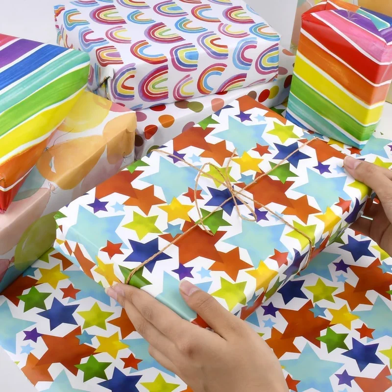 QUESERA 4-Pack PREMIUM Gift Wrapping Paper Rolls – 12 Meters | 4 Colorful Designs – Rainbows, Stars, Polka Dots & Balloons
