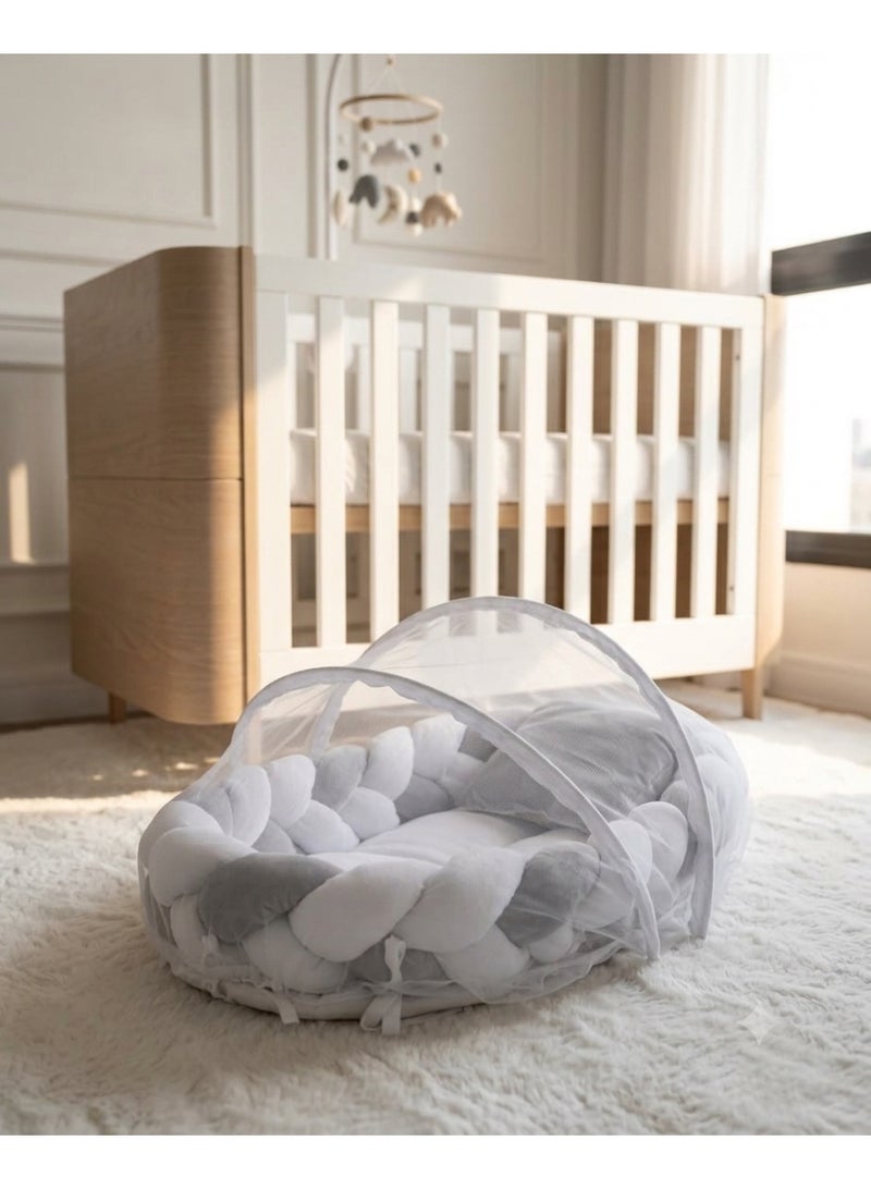 StarKids A portable newborn bed featuring a cozy nest design, a braided protective bumper, and a detachable, built-in mosquito net, ensuring a peaceful, safe, and comfortable sleeping environment for your baby—anytime, anywhere. - Image 1