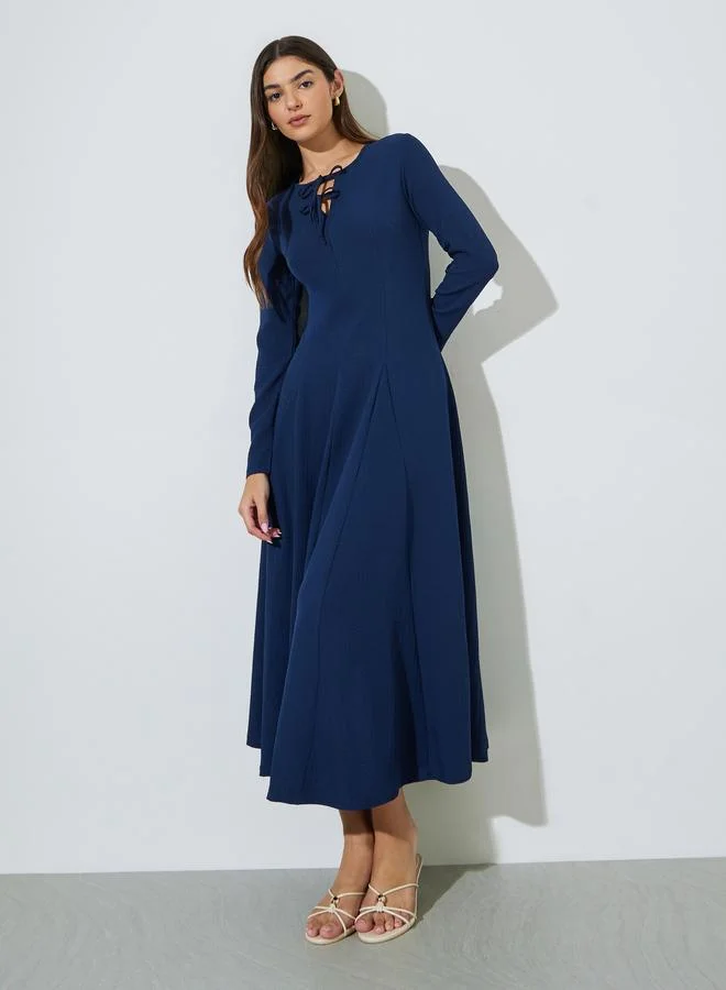 Styli Navy Blue Textured Pleated Details Tie-Up Neck A-Line Maxi Dress