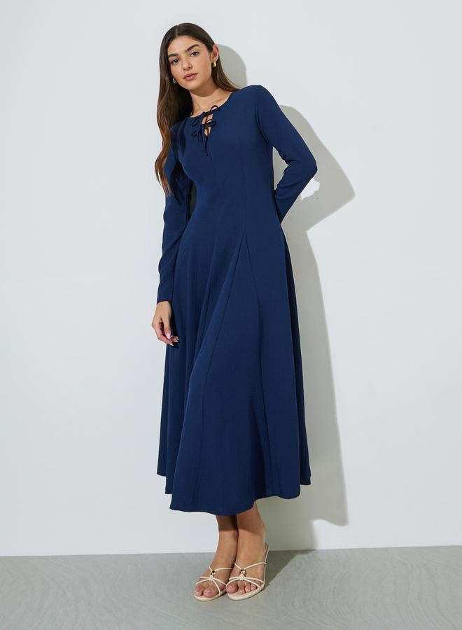 Styli Navy Blue Textured Pleated Details Tie-Up Neck A-Line Maxi Dress - Image 1