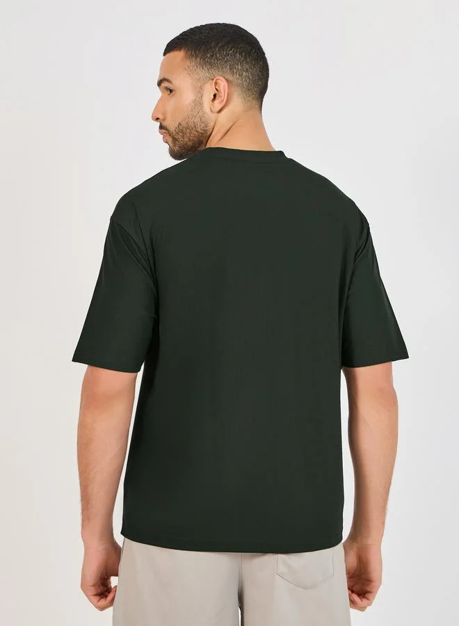 Styli Micro Pique Knit Oversized T-Shirt with Reflective Logo