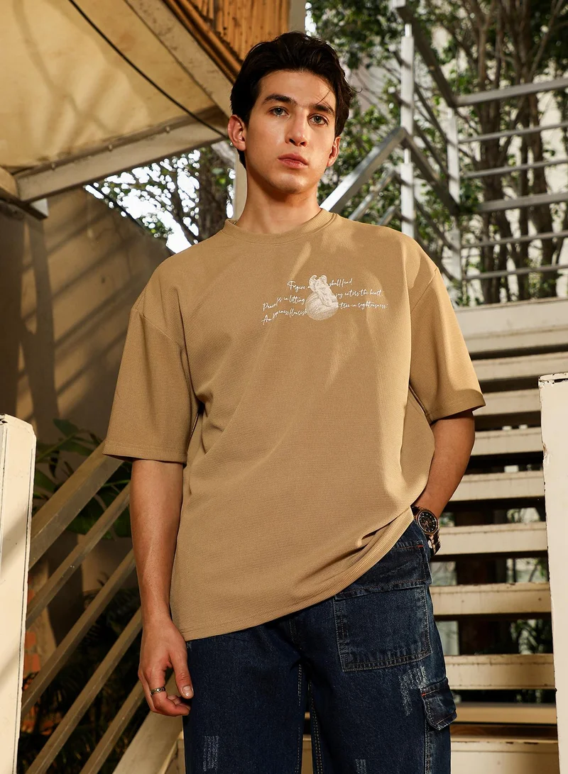 Campus Sutra Campus Sutra Men's Sand Beige Boxy Mytho-Modernism T-Shirt | Round Neck , Short  Regular Sleeves , Pull On Closure | Graphic Placement Print Waffle | Cotton-Blend T-Shirt For Casual Wear
