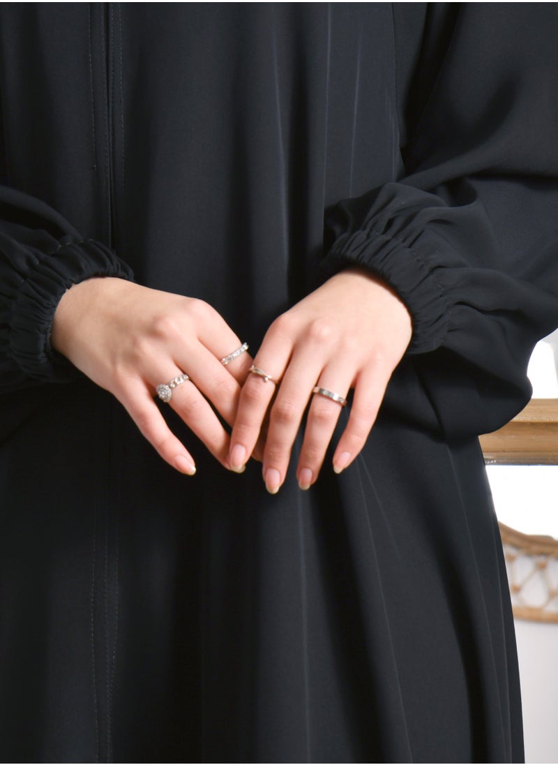 HAWRAA ABAYA - A closed abaya with a cloche cut and a slit at the back with a button and cuffed sleeves - Image 1