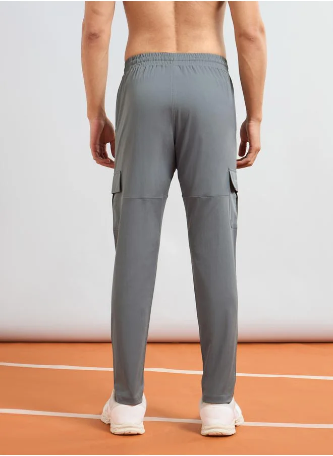 تكنوسبورت Men Solid Slim Fit Cargo Track Pants with TS FLEXI by Styli