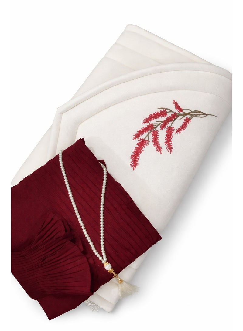 This distinctive prayer set includes a prayer mat with a foam lining in the shape of a mihrab, a plain prayer robe with pleats, and an attached headscarf. One large size for women