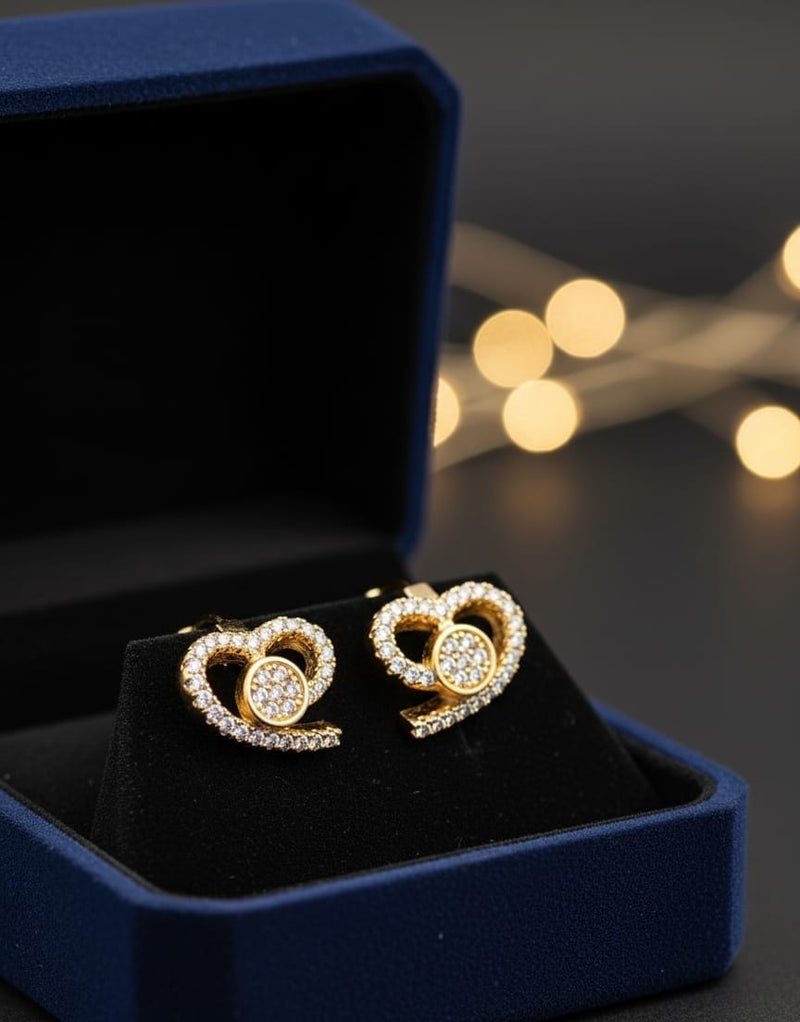 A delicate gold-plated hoop featuring a twisted heart design studded with dazzling white zircon stones. A shiny circular shape in the center adds an elegant touch. - Image 5