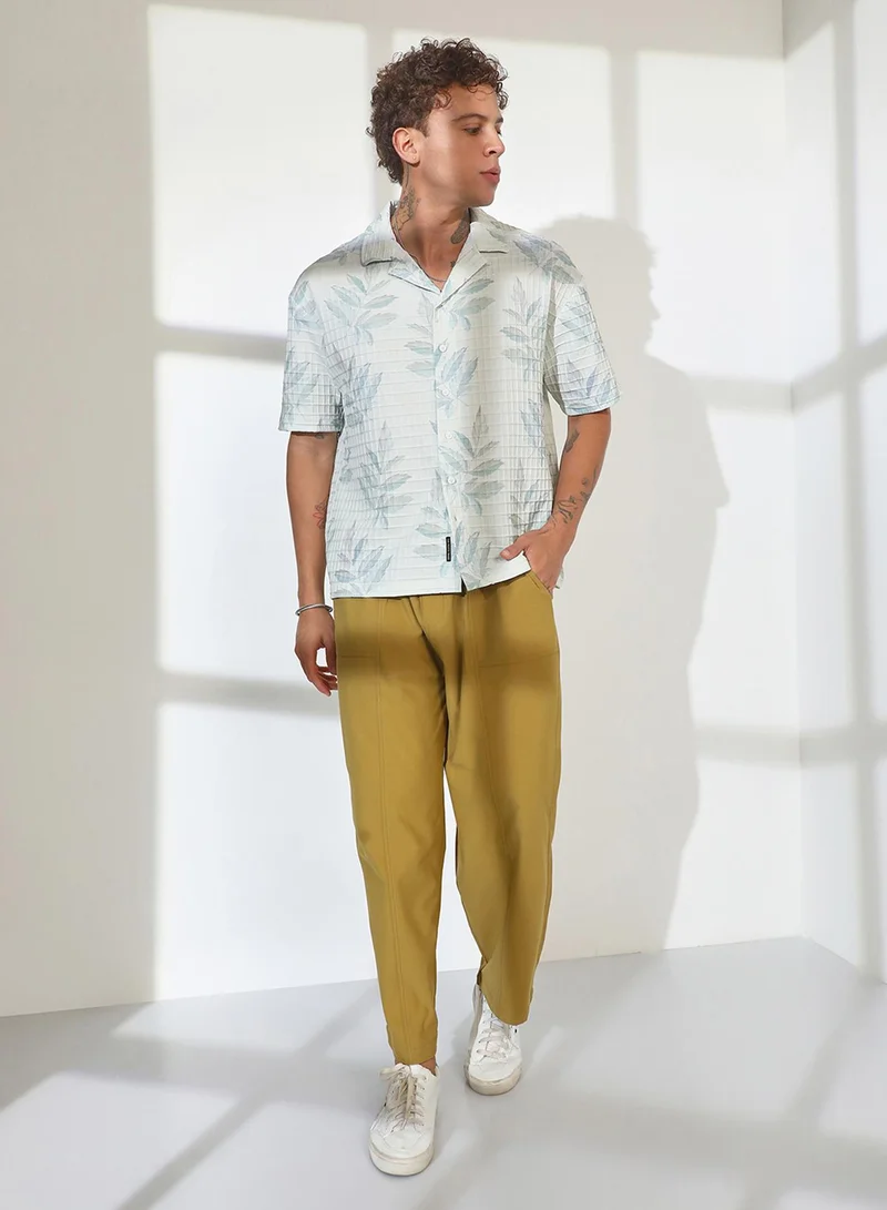 Campus Sutra Campus Sutra Men's Ivory White Faded Foliage Oversized Shirt For Casual Wear | Cuban Collar | Short Sleeve | Button Closure | Oversized Shirt Crafted With Comfort Fit For Everyday Wear