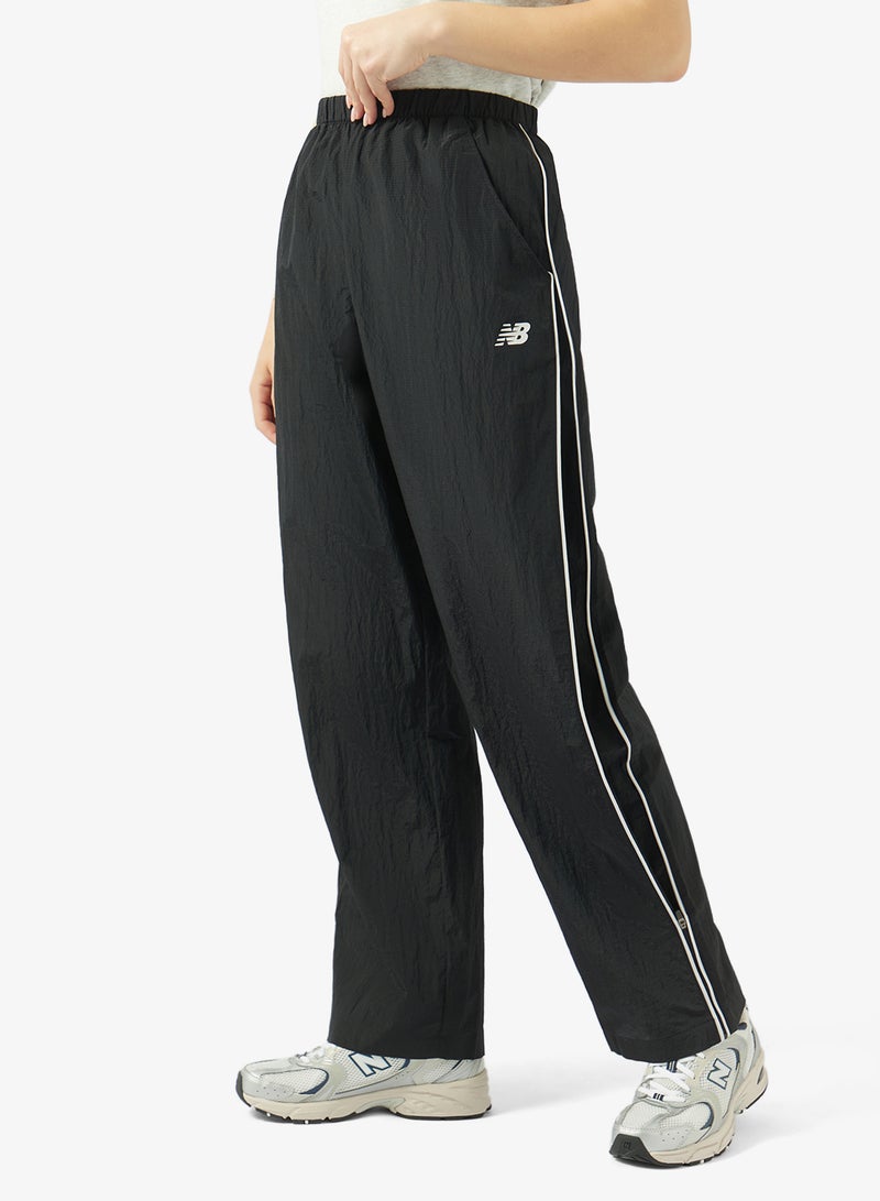 New Balance Essentia Legacy Woven Pants - Image 1