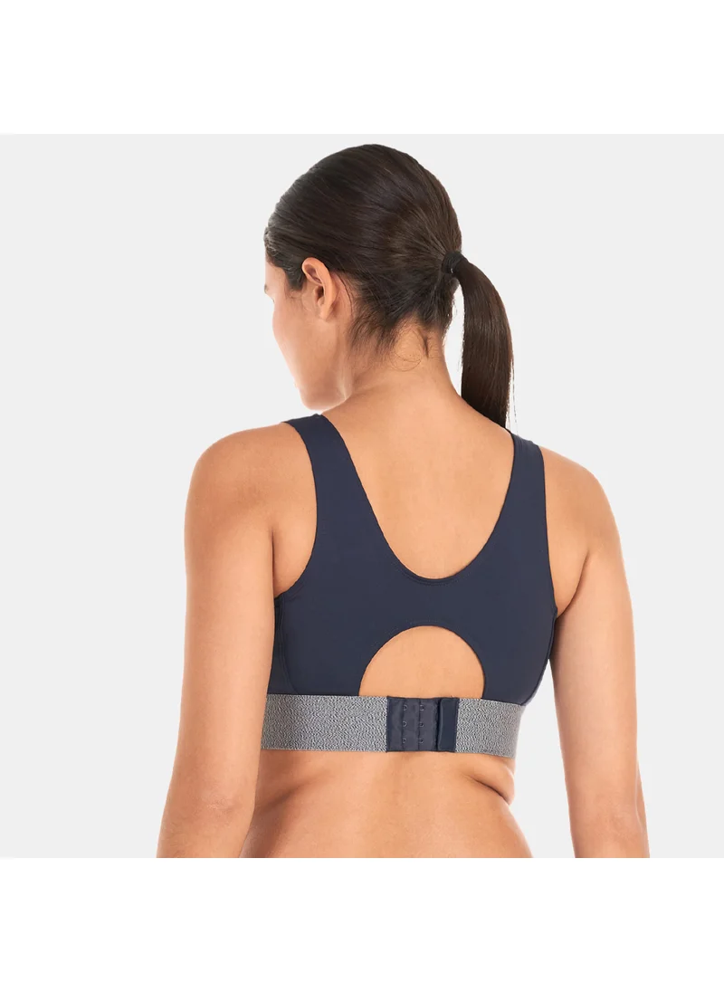 PUMA Women's RE:Collection Mid Impact Sports Bra