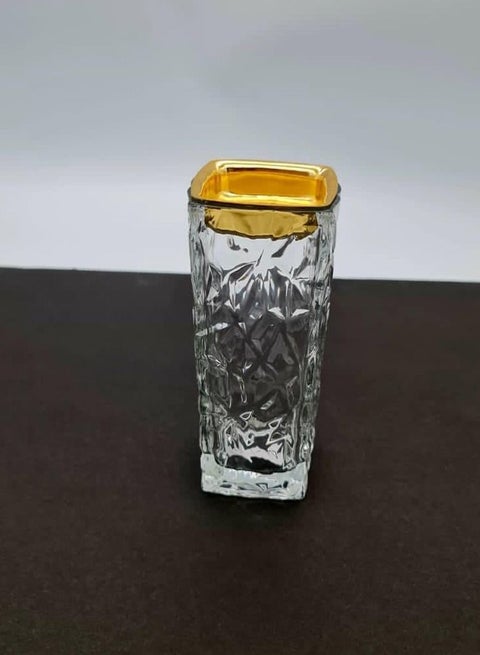 A modern incense burner made of glass with a sophisticated transparent/golden design