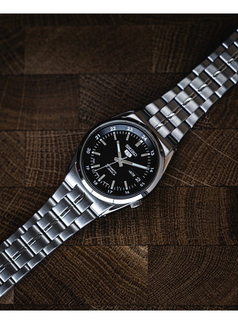 Seiko سايكو 5 أوتوماتيكي ساعة يد للرجال SNK567J1 - صنع في اليابان، قرص أسود مع علامات 24 ساعة، علبة من الفولاذ المقاوم للصدأ 36 مم، 21 جوهرة - Image 1