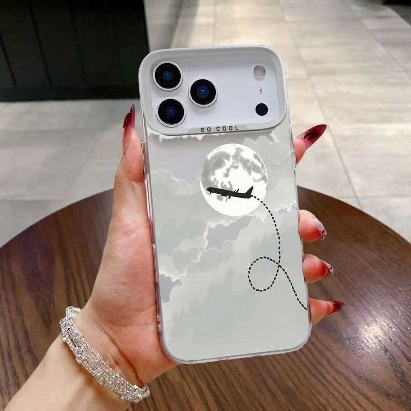 Apple iPhone 17 Pro Max phone case with a white cartoon design featuring a moon and airplane for added protection against drops
