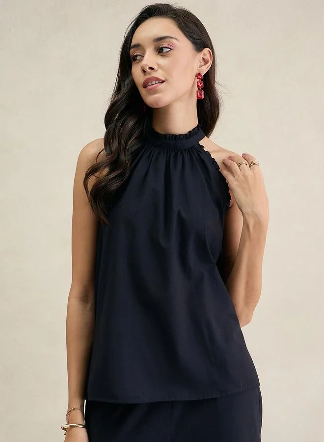 فيميلا بلوزة بياقة مربوطة بلا أكمام