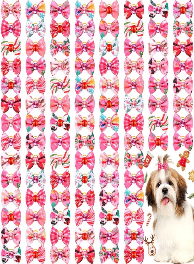 تونديامو مجموعة تونديمو من 100 قطعة من ربطات شعر الكلاب الوردية لعيد الميلاد مع أربطة مطاطية، مزينة بأحجار الراين الحمراء والبنفسجية، لتزيين شعر الجراء، على شكل عقدة علوية، مزينة بزينة شجرة الحلوى، وزينة سانتا ورنة، وإكسسوارات شعر للحيوانات الأليفة للفتيات الصغيرات. - Image 1