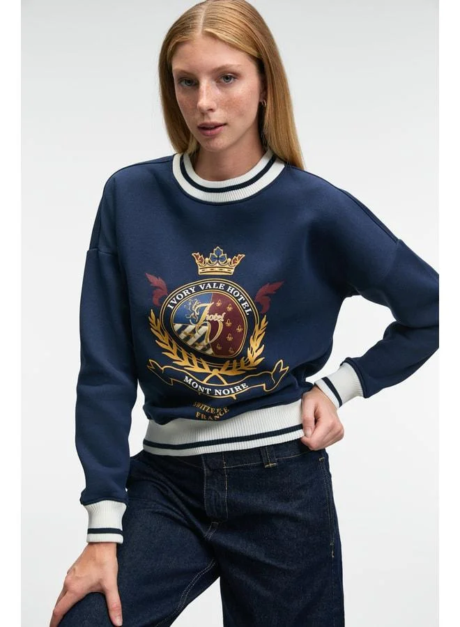 Grimelange VALLUNE Women's contrast knit, skirt‑edge sleeve and collar embroidered crop navy sweatshirt.