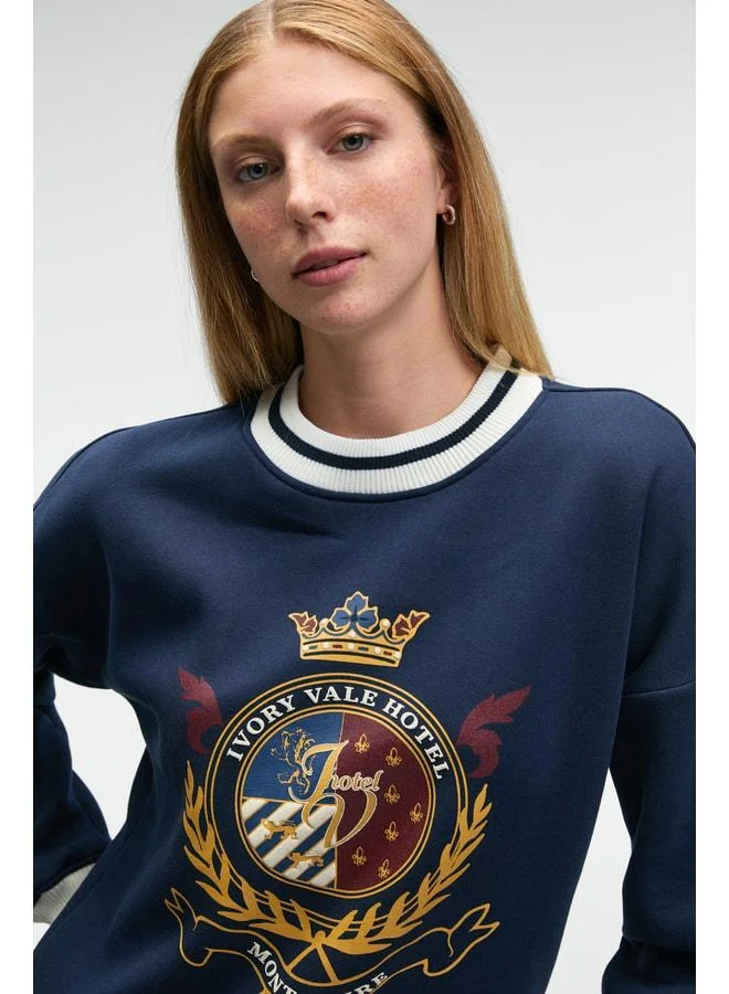 Grimelange VALLUNE Women's contrast knit, skirt‑edge sleeve and collar embroidered crop navy sweatshirt.